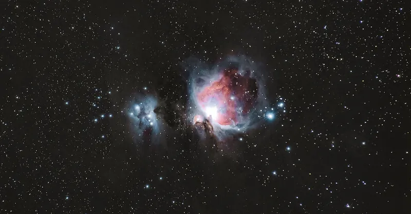 A breathtaking photograph of the Orion Nebula amidst a starry night sky, capturing celestial beauty.