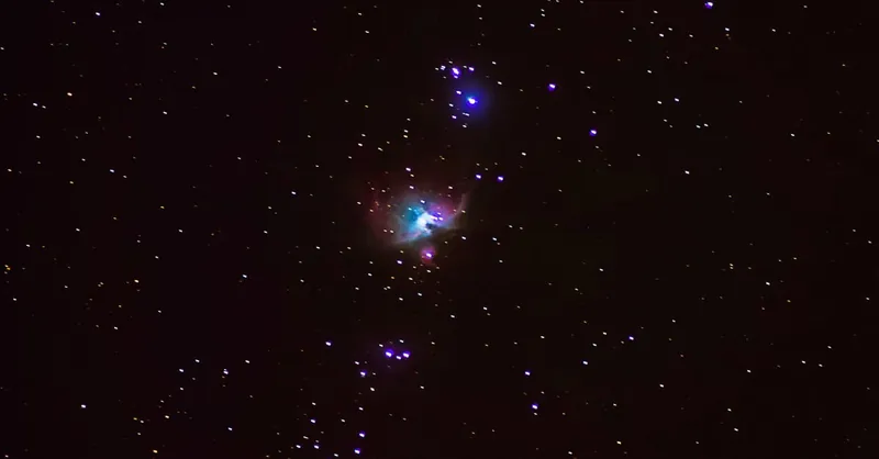 A captivating night sky photo showcasing the Orion Nebula surrounded by twinkling stars.
