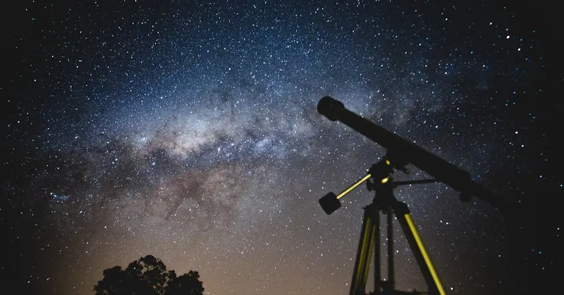 Stunning starry sky with silhouette of telescope capturing the Milky Way in Brazil.