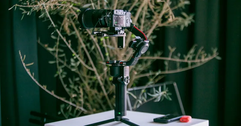 Professional camera mounted on a stabilizer with natural indoor background, ideal for photography enthusiasts.