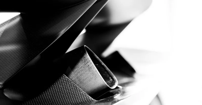 High contrast black and white detail of a carbon fiber component in modern design.