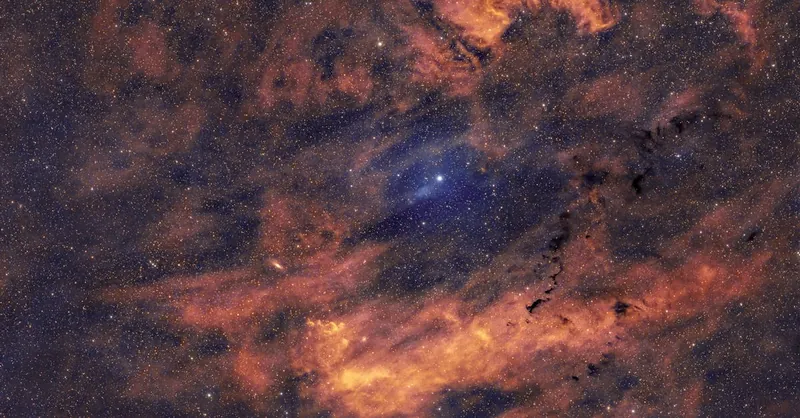 Wide view of a colorful cosmic nebula and stars, creating a mesmerizing celestial scene.