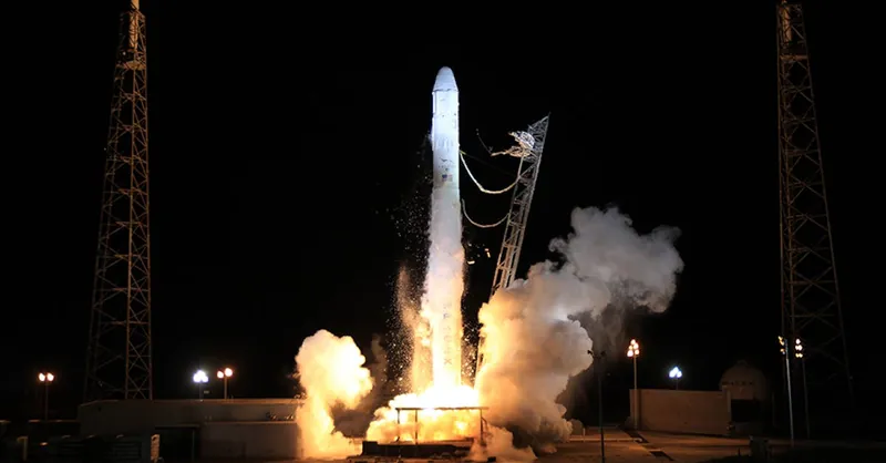 Modern solid rocket taking off into dark night sky during launching from spaceport