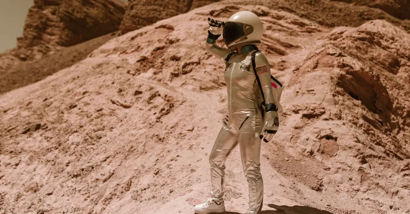 Astronaut standing on a rocky terrain resembling Mars or Moon, pondering future space exploration.