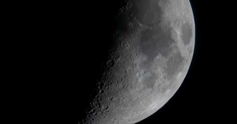 Detailed view of the crescent moon showcasing its craters and lunar surface.
