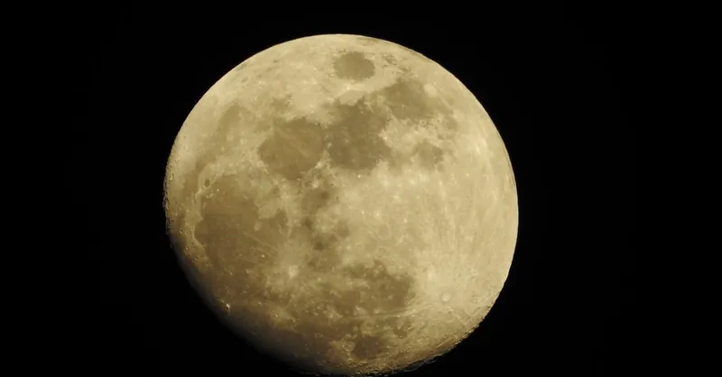 Detailed photograph of a full moon set against a dark night sky, highlighting lunar features.