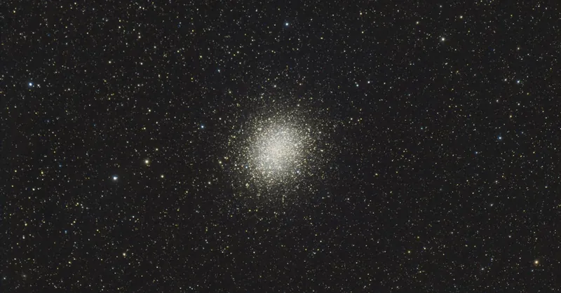 A breathtaking image of a dense star cluster shining brightly against a rich dark sky.
