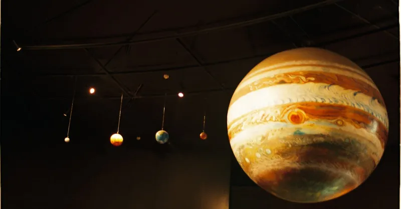 Scale models of solar system planets in a planetarium exhibit.