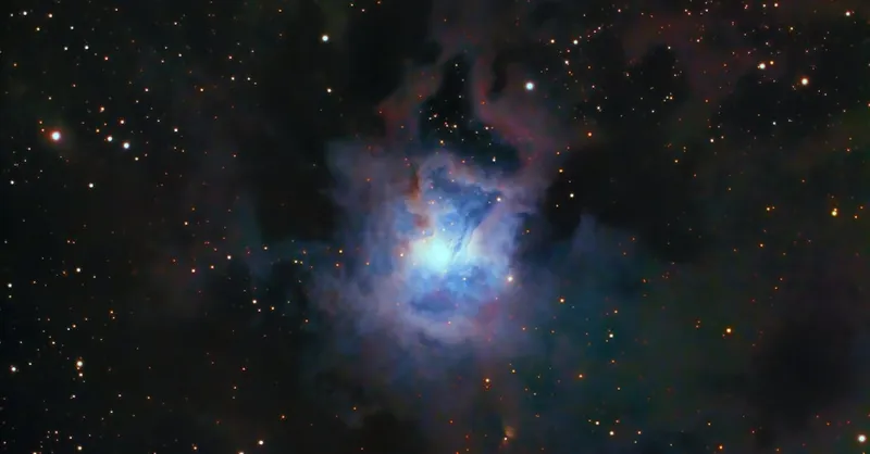 Vivid capture of the NGC 7023 Iris Nebula, surrounded by stars and cosmic dust.