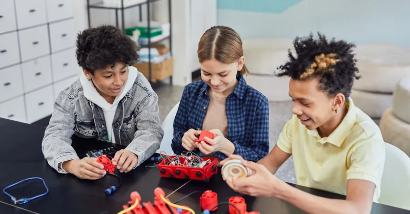 Children collaborating on a robotics project, showcasing teamwork and STEM learning indoors.