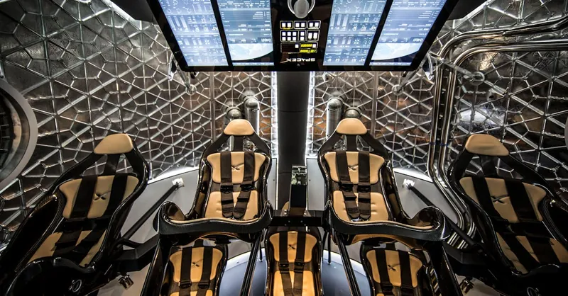 Modern spacecraft cabin showing ergonomic seats and digital control panels in a sophisticated interior.