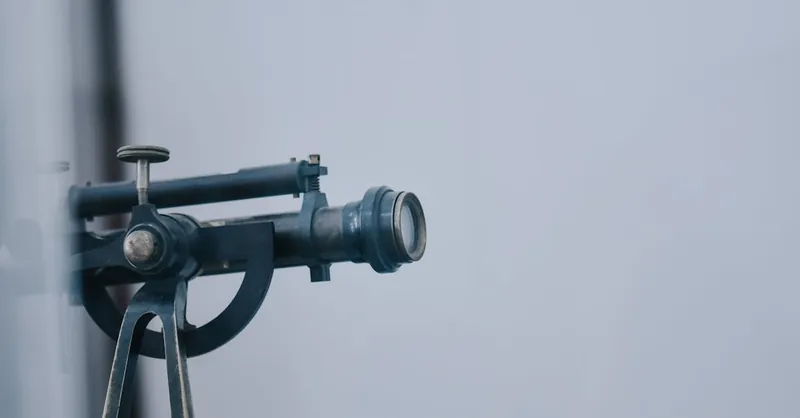 A close-up view of a vintage telescope lens showcasing intricate details and metal components.