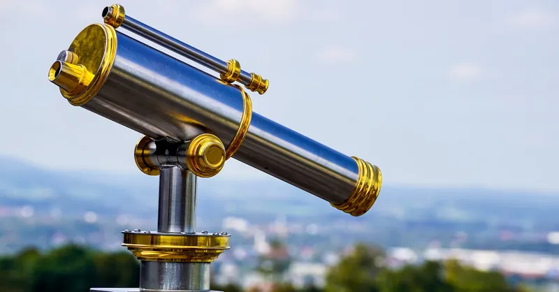 Close-up of a stainless steel telescope on a bright day.